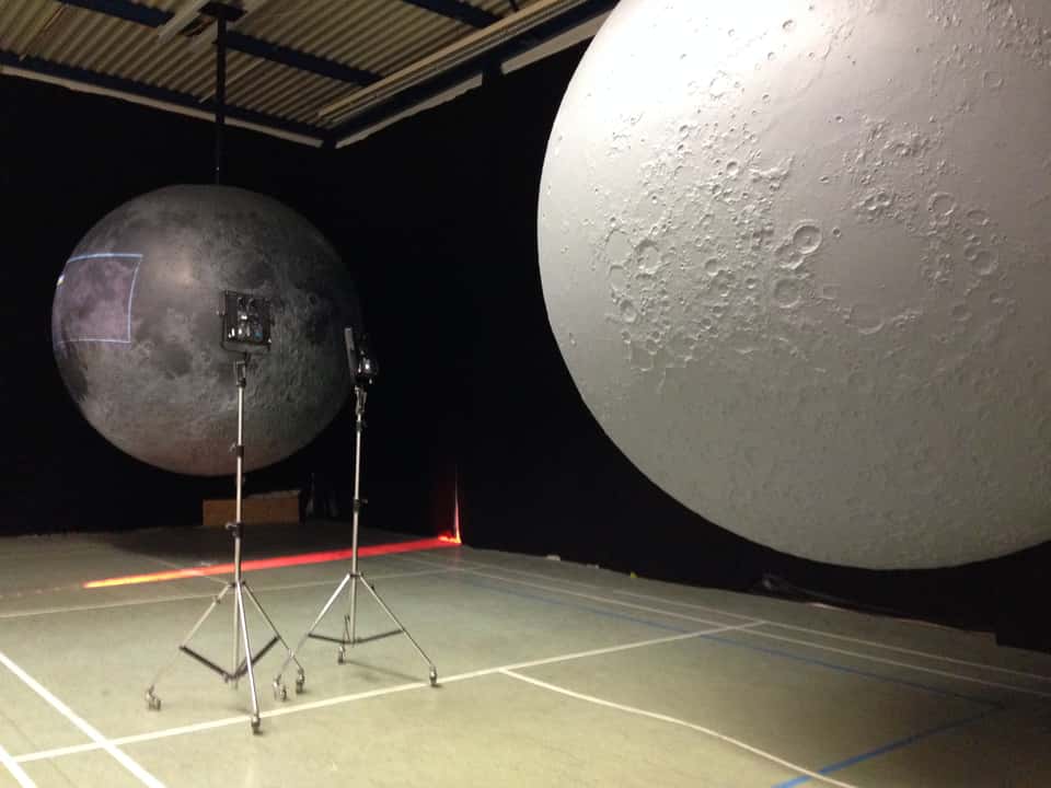 Two physically built, five-meter moon models with live projection and synchronized rotation, showing a 3D visualization of the moon's surface with interactive elements.