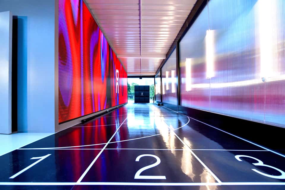 View of LED wall and a run track in an On Running store.